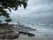 Stone stack on beach in Samed, Thailand. cloudy and big waves.