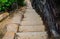 Stone stair steps walking the trail, Smugglers Track with the natural black stone wall at Barrenjoey Lighthouse Walk.