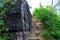 Stone stair steps walking the trail, Smugglers Track with the natural black stone wall at Barrenjoey Lighthouse Walk.