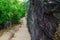 Stone stair steps walking the trail, Smugglers Track with the natural black stone wall at Barrenjoey Lighthouse Walk.