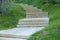 A stone staircase leads deep into the lawn