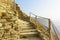 A stone staircase on a steep mountain slope above the sea