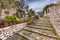 Stone stairs in alley with gardens on Lesbos island Greece