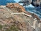 Stone stairs in rock leading down to the sea. Ancient stone steps in the rock. Stairs to the sea. Nature, cliffs and coastline