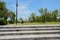 Stone stairway before wayside streetlamp in sunny summer afternoon