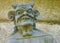 Stone statue representing a devil on the facade of the Saint-Yves church in Plougonven