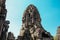 Stone statues of faces in Cambodian Angkor Wat Temple near Siem Reap city in Asia