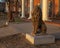 Stone statues of a sitting lion in front of the Sigma Alpha Epsilon Fraternity House on the campus of the University of Arkansas.