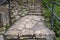 Stone steps ascend a green hillside