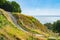 Stone steps down track up Mount Maunganui with view beyond to Pacific Ocean