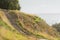 Stone steps down track up Mount Maunganui with view beyond to Pacific Ocean