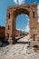 Stone street and remains of arc in Pompeii Italy. Pompei was des