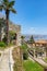 Stone structures and greenery in landscape gardens on sunny day in spring in Opatija, Croatia.