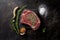 On a stone surface, there is fresh, raw marbled beef rib-eye steak with spices. AI