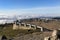 Stone terrace overlooking the mountains and the valley, wooden benches and tables