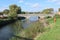 A stone three arch bridge over the River Parrett in Langport, Somerset as it flows through the public park