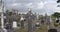 Stone tombstones and Celtic crosses in the Catholic cemetery. Overcast cloudy sky, Christian cemetery in Ireland