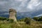 A stone tower in the dark weather.