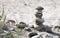 Stone tower and plants on a natural sandy beach