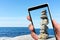 Stone tower on smartphone screen.