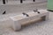 Stone town bench seat with center arm steel rests on hostile design prevents for people homeless from laying down in city center