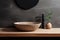 Stone vessel sink against textured stone wall in minimal bathroom