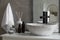 Stone vessel sink with faucet and toiletries on white countertop in bathroom