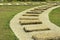 Stone walk paths in the park with green grass