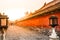 Stone Walking Path side of red wall of Forbidden Palace with bright sunset background