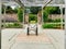 A stone walkway leads to chairs in a garden. Closer view.