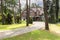 Stone walkway in the middle of forest to english red brick residence in the summer