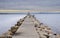 Stone walkway over calm sea at sunset time, Rosas bay , Costa Brava, Spain