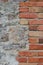 Stone wall background closeup, vertical plastered grunge red brick stonewall, beige limestone pattern, old aged weathered beige