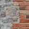 Stone wall background closeup, vertical plastered grunge red brick stonewall, beige limestone pattern, old aged weathered beige