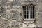 Stone Wall and barred window of Spanish Mission Espada