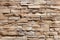 Stone wall brick background featuring a seamless pattern of sandstone facade.