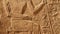 Stone wall with carved ancient Egyptian bas relief