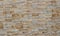 Stone wall cladding for exterior made of rock stripes panels . The colors are shades of light brown and gray