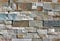 Stone wall cladding made of natural rocks bricks with different sizes and colors