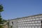 Stone wall with concrete and fittings against the blue sky