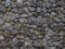 Stone wall of dark rough cobblestone