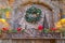 Stone wall decorated with enchanting Christmas ornaments and warm lights