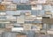 Stone wall detail with natural worked rocks of different shapes and colors.