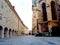 stone wall detail of the Zagreb cathedral with cloister on the opposite side of cobblestone paved road