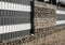 Stone wall-gabions. An unusual type of house fencing
