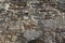 Stone wall grunge rough texture background. Rough old stone or rock of mountains. Grungy vintage fortress granite and sandstone.