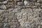 Stone wall grunge rough texture background. Rough old stone or rock of mountains. Grungy vintage fortress granite and sandstone.