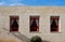 Stone wall of the house with three windows