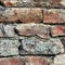 Stone wall macro closeup, stonewall pattern background, old aged weathered red and grey grunge limestone dolomite