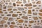 Stone Wall Made From Granite Rocks With White Honeycomb Pattern